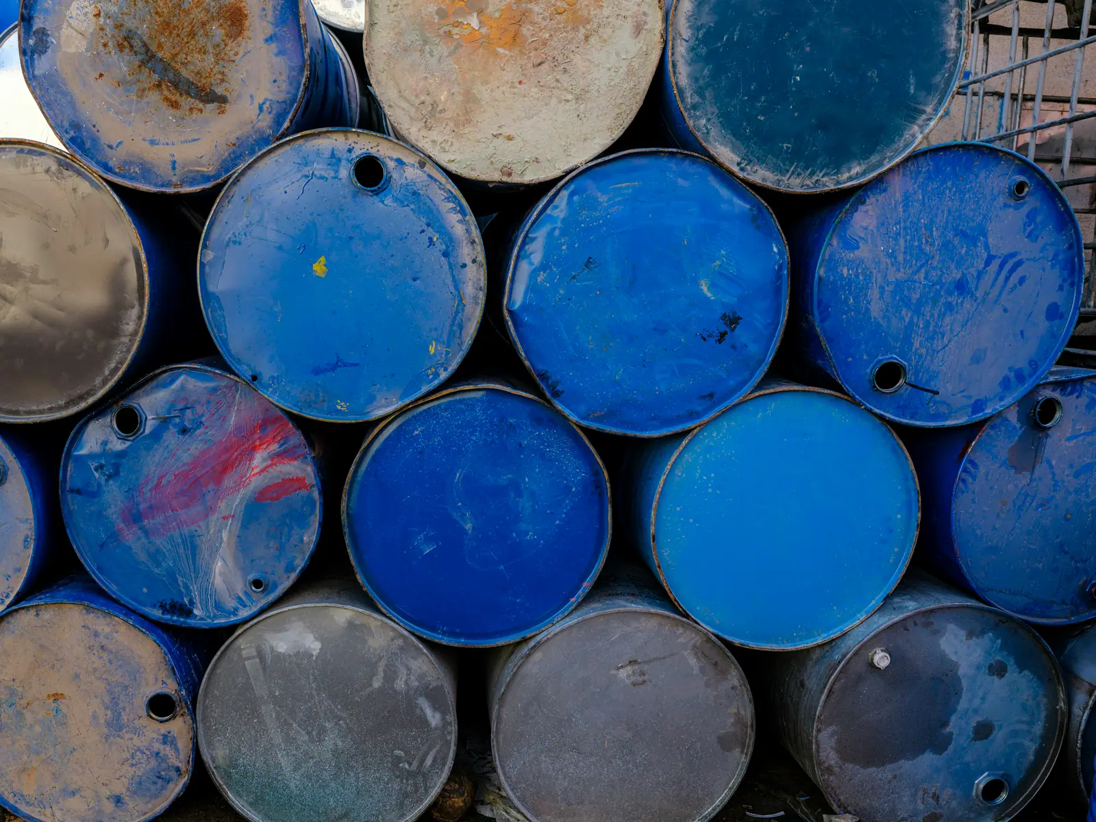 Stacked steel industrial drums in blue and grey